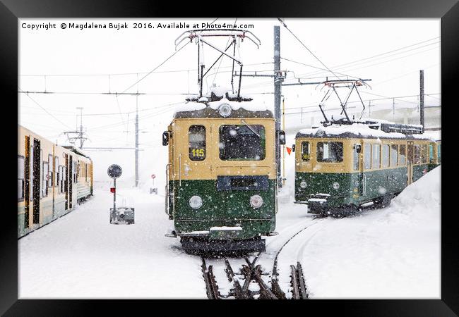 Trains in heavy snow at Kleine Scheidegg station Framed Print by Magdalena Bujak
