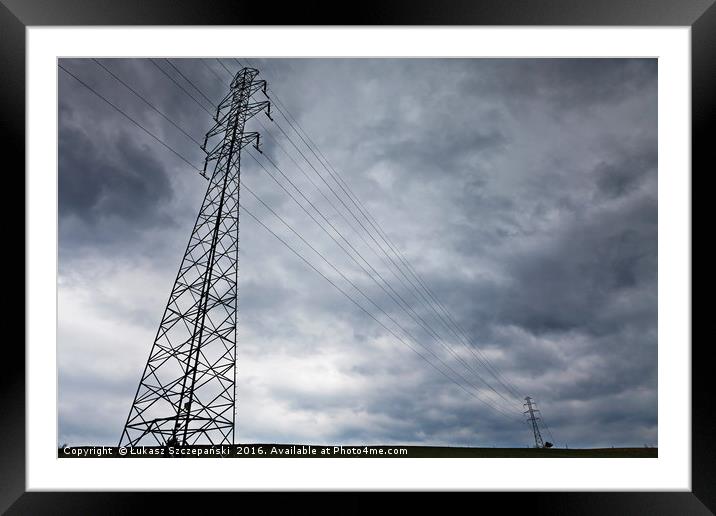 High-voltage power line against dark stormy clouds Framed Mounted Print by Łukasz Szczepański