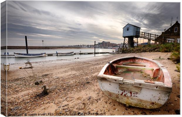Old rowing boat and lookout tower on beach Canvas Print by Simon Bratt LRPS
