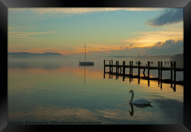 lonely swan on windermere Framed Print by martin pulling