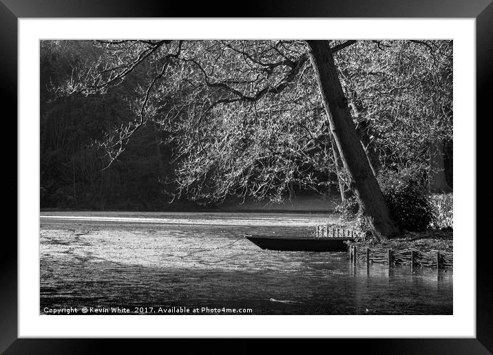 Boat on icy lake Framed Mounted Print by Kevin White