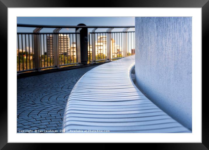 Curved riverwalk seat in shade Framed Mounted Print by Ian Leishman