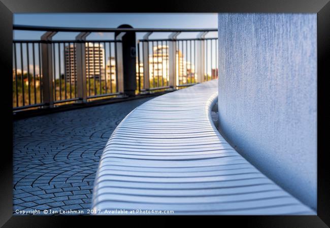 Curved riverwalk seat in shade Framed Print by Ian Leishman