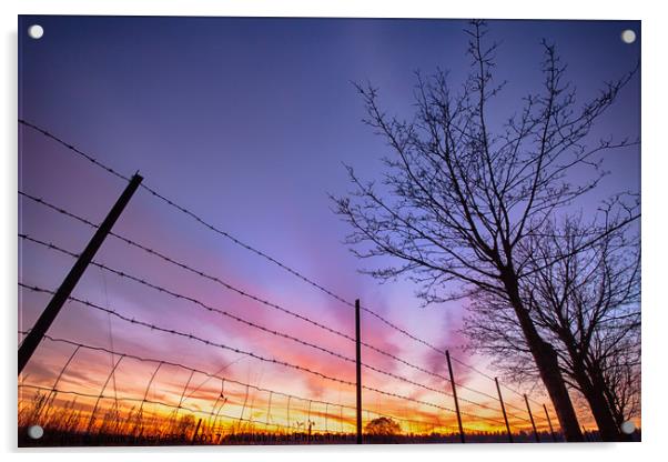 Fiery sunset viewed through barbed fence Acrylic by Simon Bratt LRPS