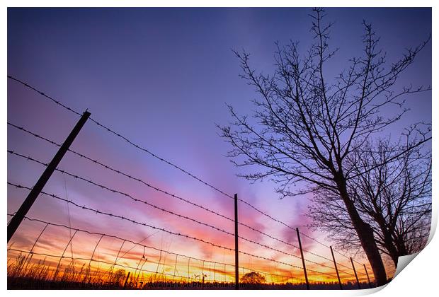 Fiery sunset viewed through barbed fence Print by Simon Bratt LRPS