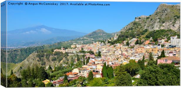 Taormina, Sicily with Mount Etna in background Canvas Print by Angus McComiskey