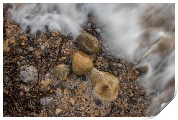 Pebbles being washed over by the incoming tide. Print by Bryn Morgan