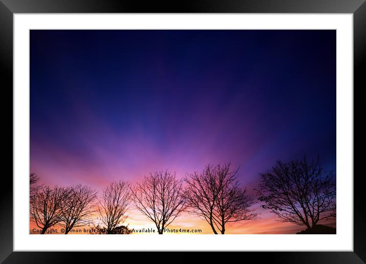 Fiery winter sunset with line of bare trees Framed Mounted Print by Simon Bratt LRPS