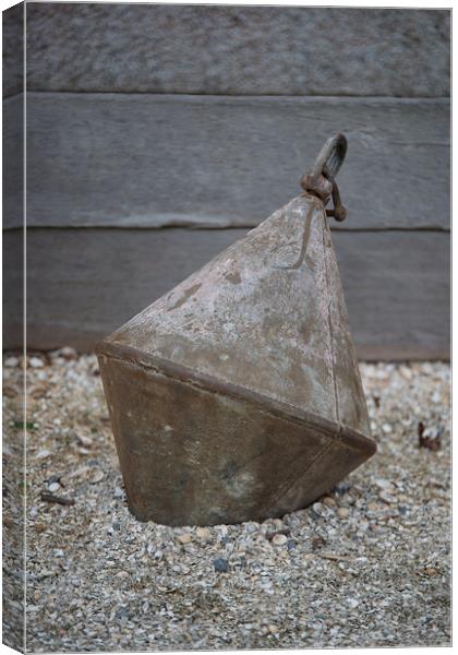 Old metal buoy on shingle. Canvas Print by Bryn Morgan