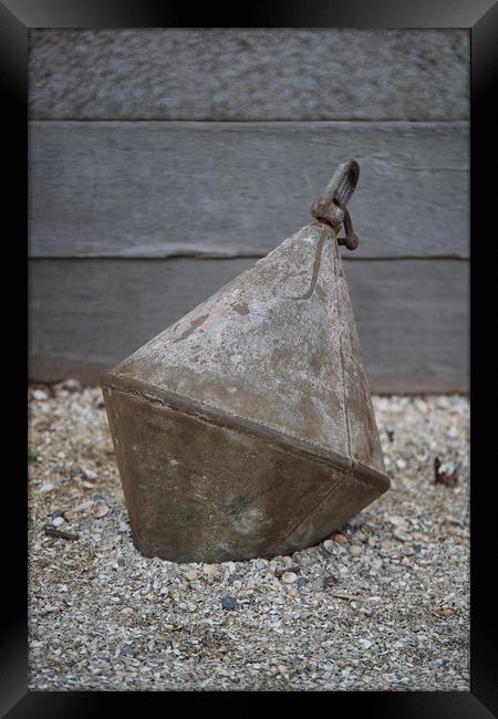 Old metal buoy on shingle. Framed Print by Bryn Morgan