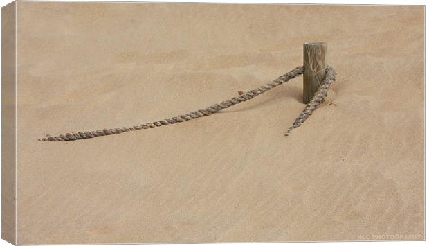 Rope in the Sand Canvas Print by Nigel Coomber