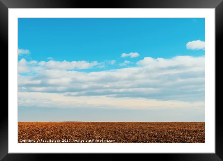 Cloudy Sky Over Harvested Land In Autumn Framed Mounted Print by Radu Bercan