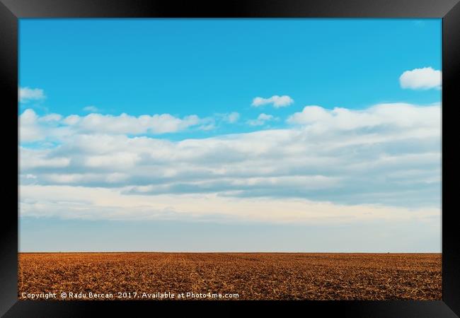 Cloudy Sky Over Harvested Land In Autumn Framed Print by Radu Bercan