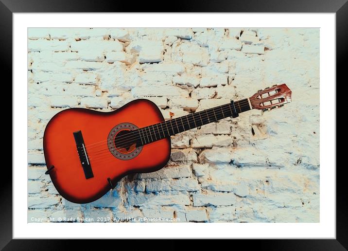 Common Guitar On White Brick Wall Framed Mounted Print by Radu Bercan