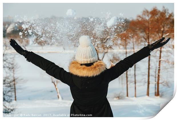 Happy Girl Throwing Snow In Air During Winter Print by Radu Bercan