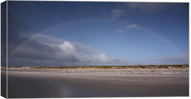 Rainbow over beach Canvas Print by Paul Davis
