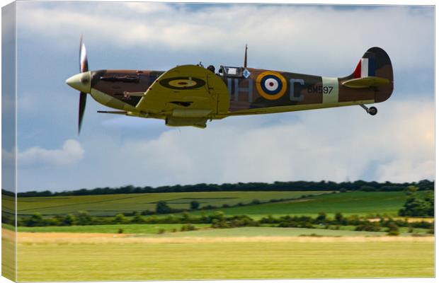 Low flying Spitfire over Duxford Canvas Print by Oxon Images