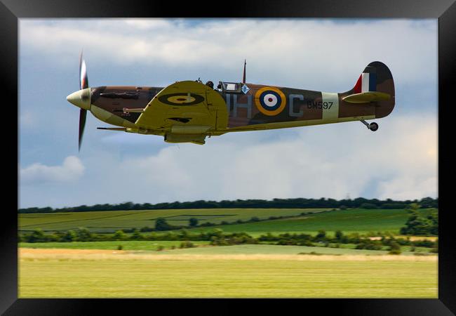 Low flying Spitfire over Duxford Framed Print by Oxon Images