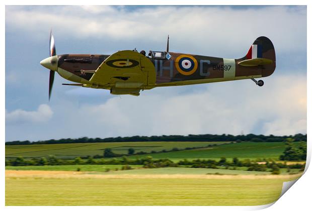 Low flying Spitfire over Duxford Print by Oxon Images