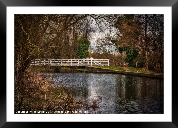 Tranquil swing bridge over the KA Framed Mounted Print by Ian Lewis