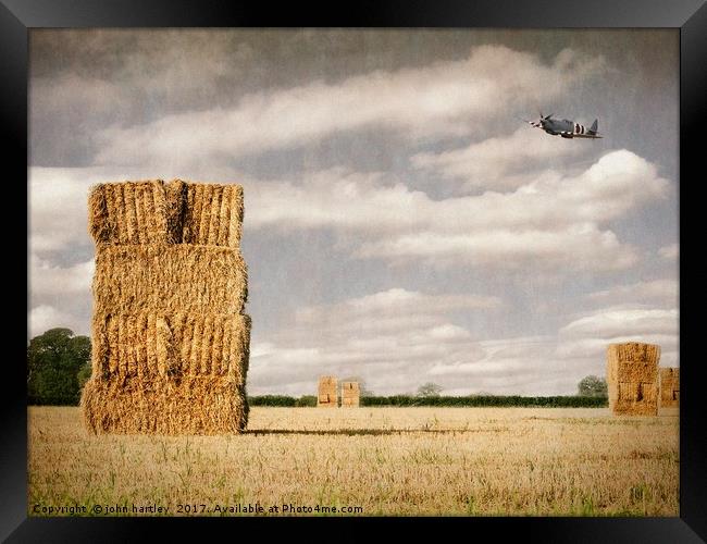  Spitfire at low level over a Cornfield with Hayst Framed Print by john hartley
