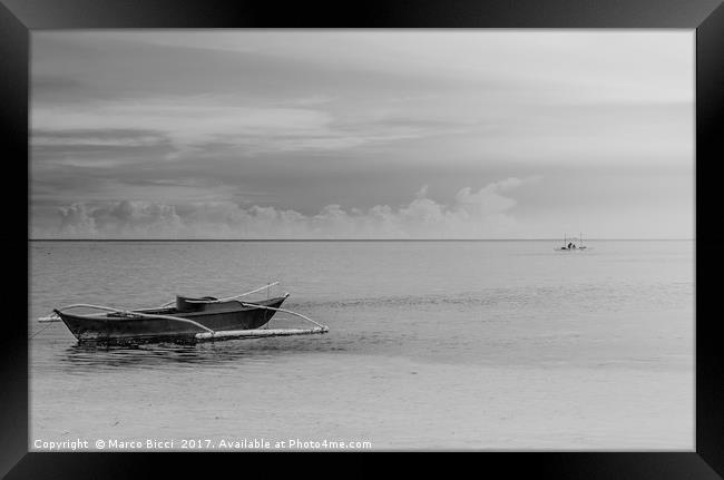 A filipino boat with a fisherman at the horizon Framed Print by Marco Bicci
