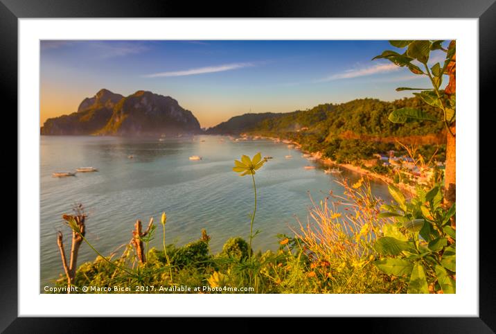 Close up of a yellow flower with El Nido Town in b Framed Mounted Print by Marco Bicci