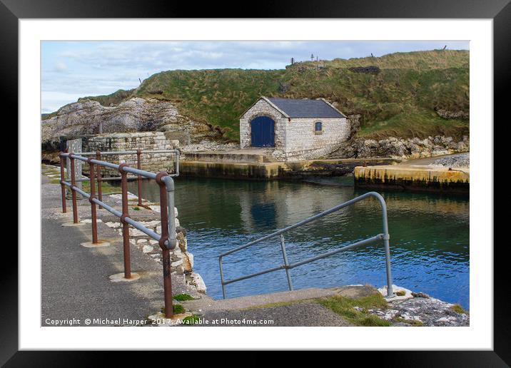 The stone boathouse and slipway at Ballintoy Harbo Framed Mounted Print by Michael Harper