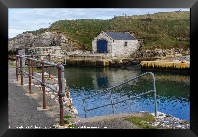 The stone boathouse and slipway at Ballintoy Harbo Framed Print by Michael Harper