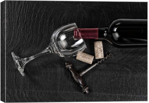 Overhead view of vintage corkscrew with red wine b Canvas Print by Thomas Baker