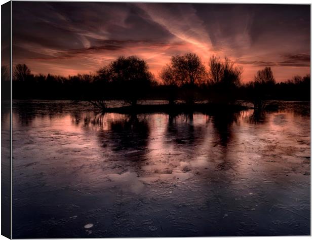 Frozen lake in winter Canvas Print by Nick Lukey