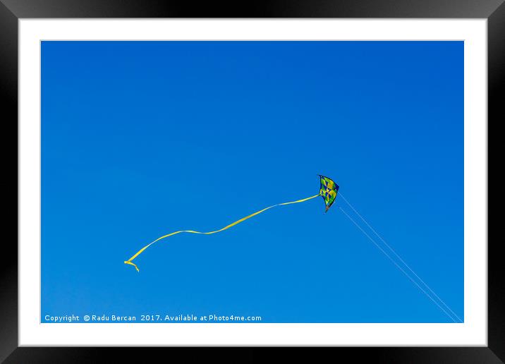 Colorful Kite Flying In Summer Blue Sky Framed Mounted Print by Radu Bercan