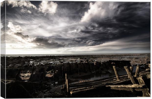 Storm clouds over beached shipwreck Canvas Print by Simon Bratt LRPS