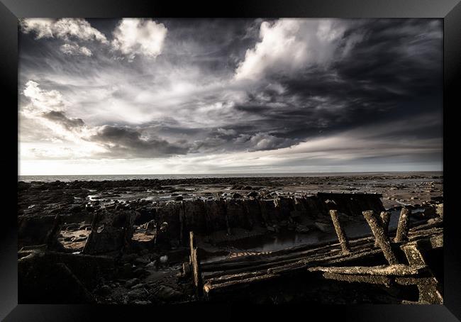 Storm clouds over beached shipwreck Framed Print by Simon Bratt LRPS