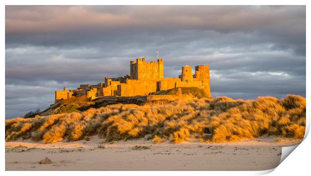 Sun setting on Iconic Bamburgh Castle Print by Naylor's Photography