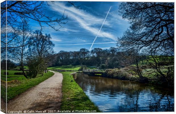 Vapour trails over the canal. Canvas Print by Colin Metcalf