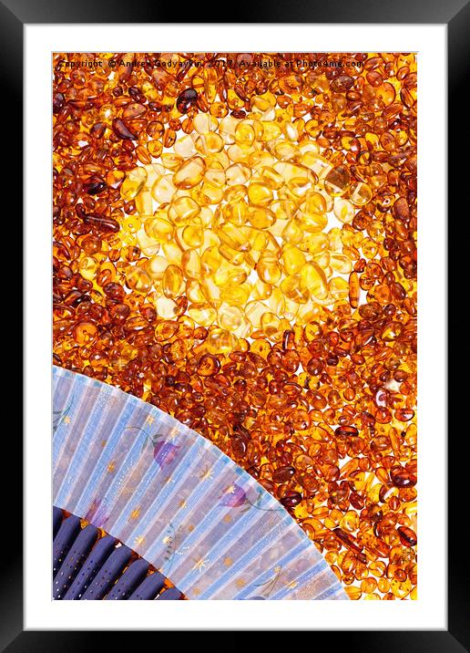Stones of yellow amber and a blue fan. Framed Mounted Print by Andrey  Godyaykin
