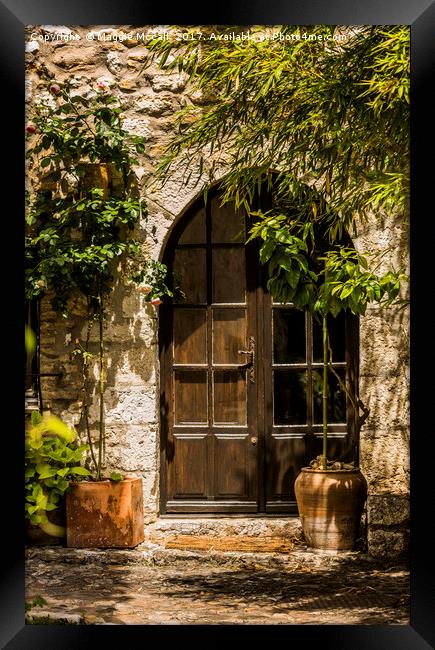 A Shadowy Door in Saint Paul de Vence, France. Framed Print by Maggie McCall