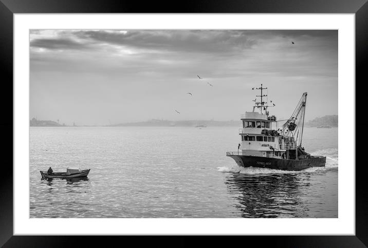 A fishing trawler sales on the river Bosphorus in  Framed Mounted Print by George Cairns
