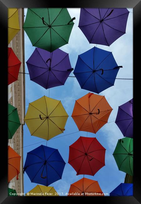 Colorful umbrellas Framed Print by Marinela Feier
