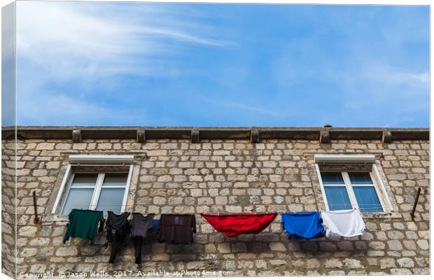 Looking up at laundry on the line Canvas Print by Jason Wells