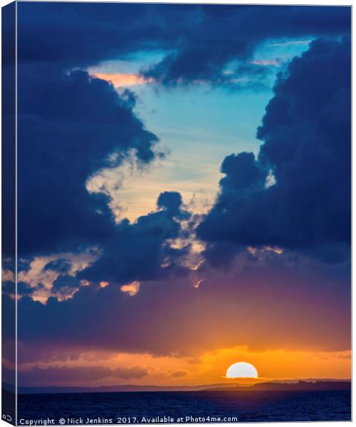 Sunset between the clouds and the Sea Canvas Print by Nick Jenkins
