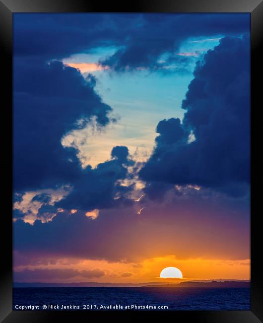 Sunset between the clouds and the Sea Framed Print by Nick Jenkins