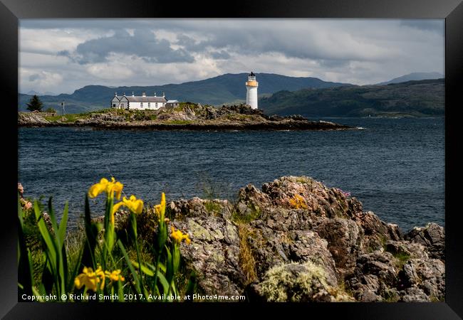 Lighthouse with foreground Flags Framed Print by Richard Smith