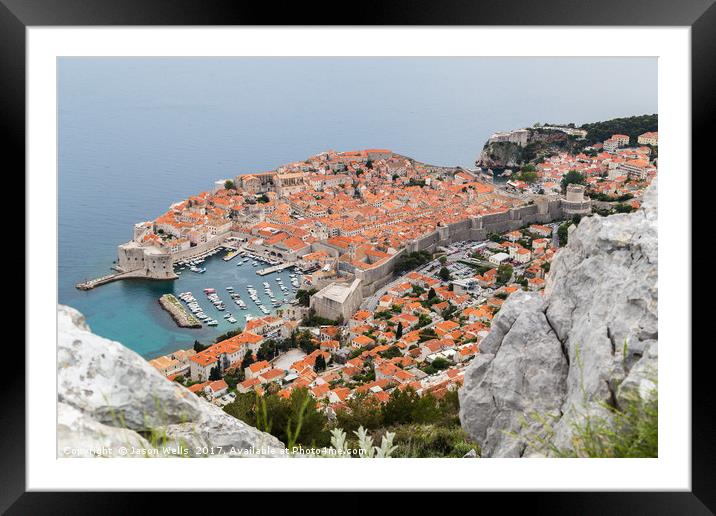 Dubrovnik seen between the rocks on Srd hill Framed Mounted Print by Jason Wells