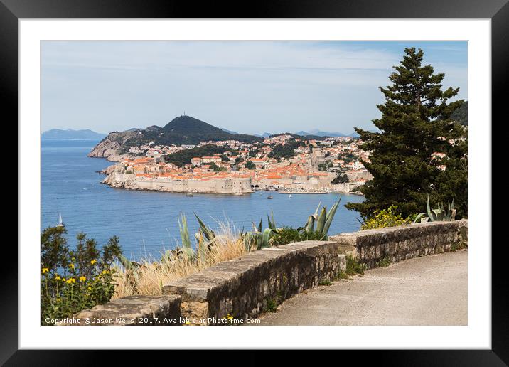 Dubrovnik's old town seen over a curving coastal r Framed Mounted Print by Jason Wells