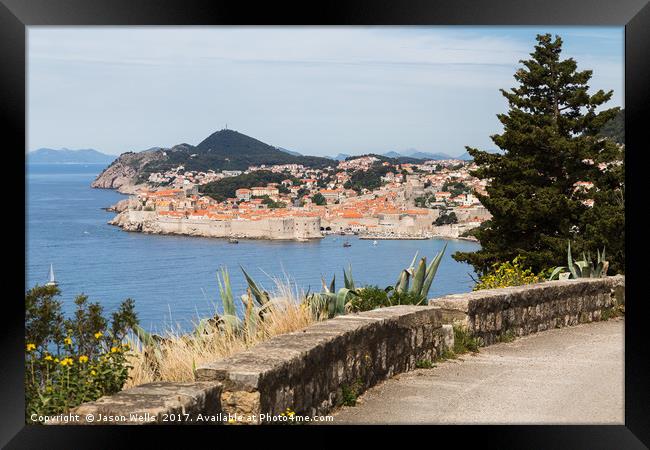 Dubrovnik's old town seen over a curving coastal r Framed Print by Jason Wells