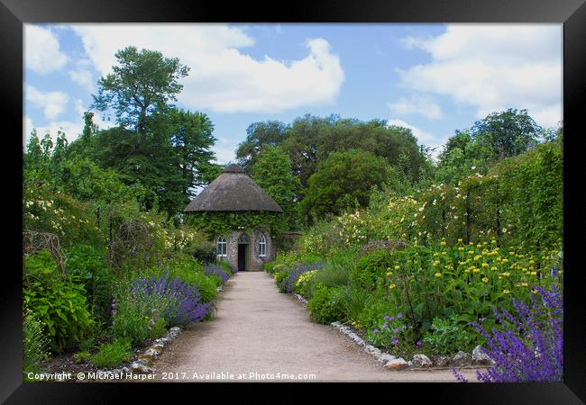 The thatched Round House in West Dean Gardens in W Framed Print by Michael Harper