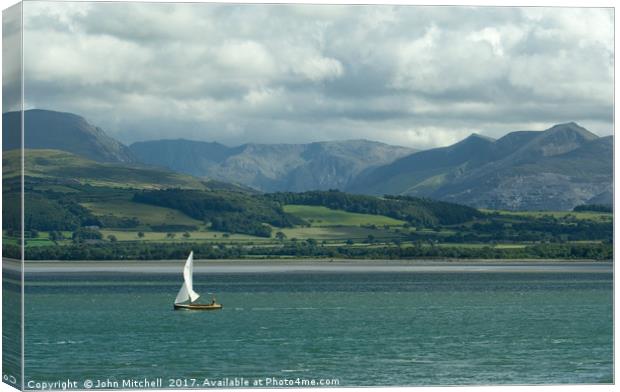 Snowdonia from the Menai Straits on a cloudy day Canvas Print by John Mitchell