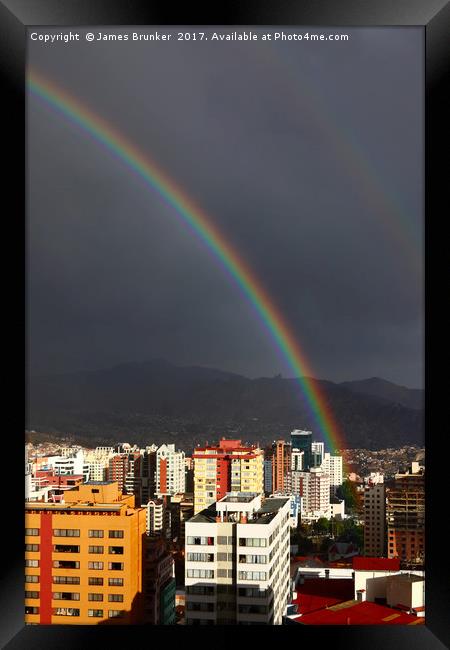 Rainbow Above La Paz CIty Centre Bolivia Framed Print by James Brunker